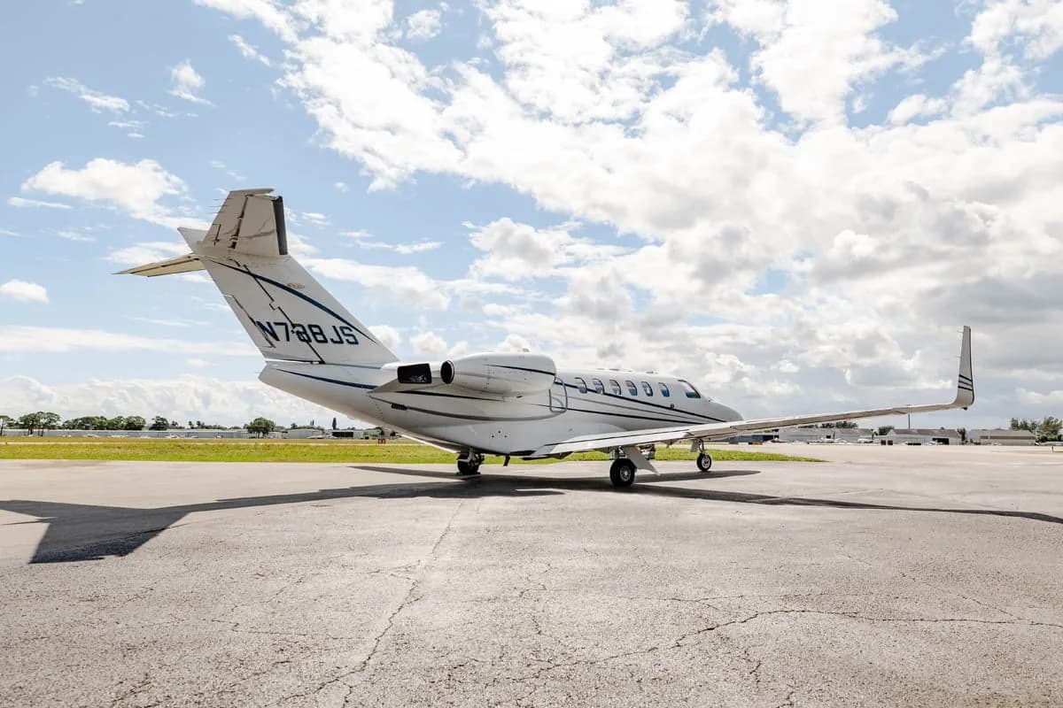 Rear-side view of a white Cessna Citation private jet with registration N788JS parked on the tarmac.