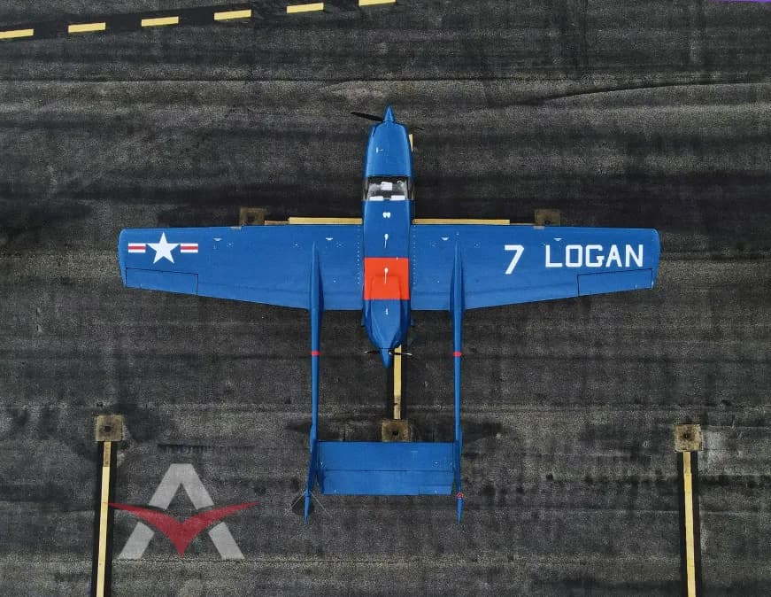 Top-down view of a blue and orange Cessna Skymaster on a runway.