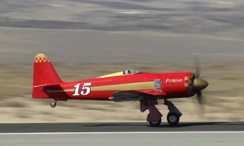 Side view of a red and gold Furias aircraft with the number 15 on the side.