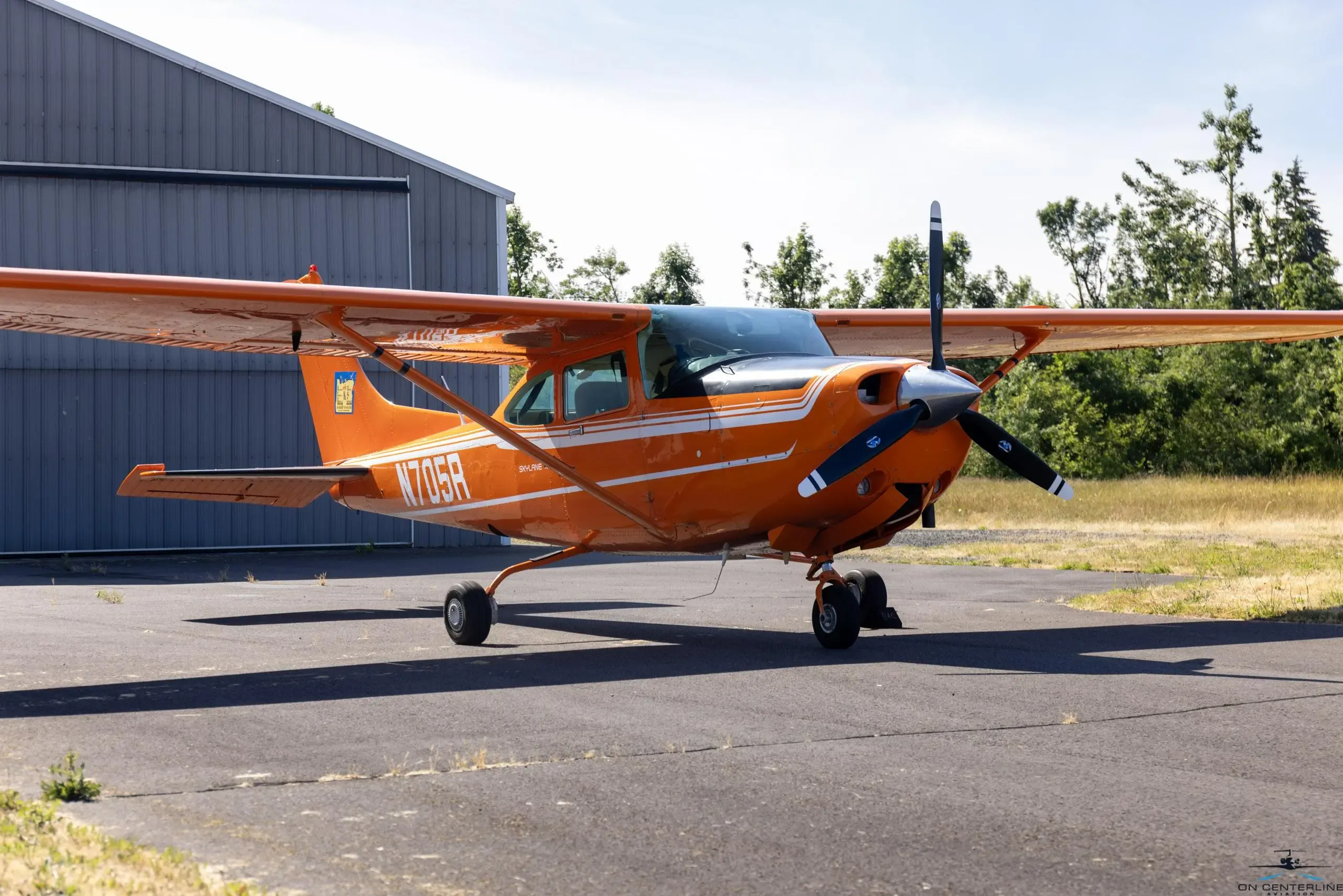 Front quarter view of the orange and white Cessna 182 Skylane RG on the tarmac.