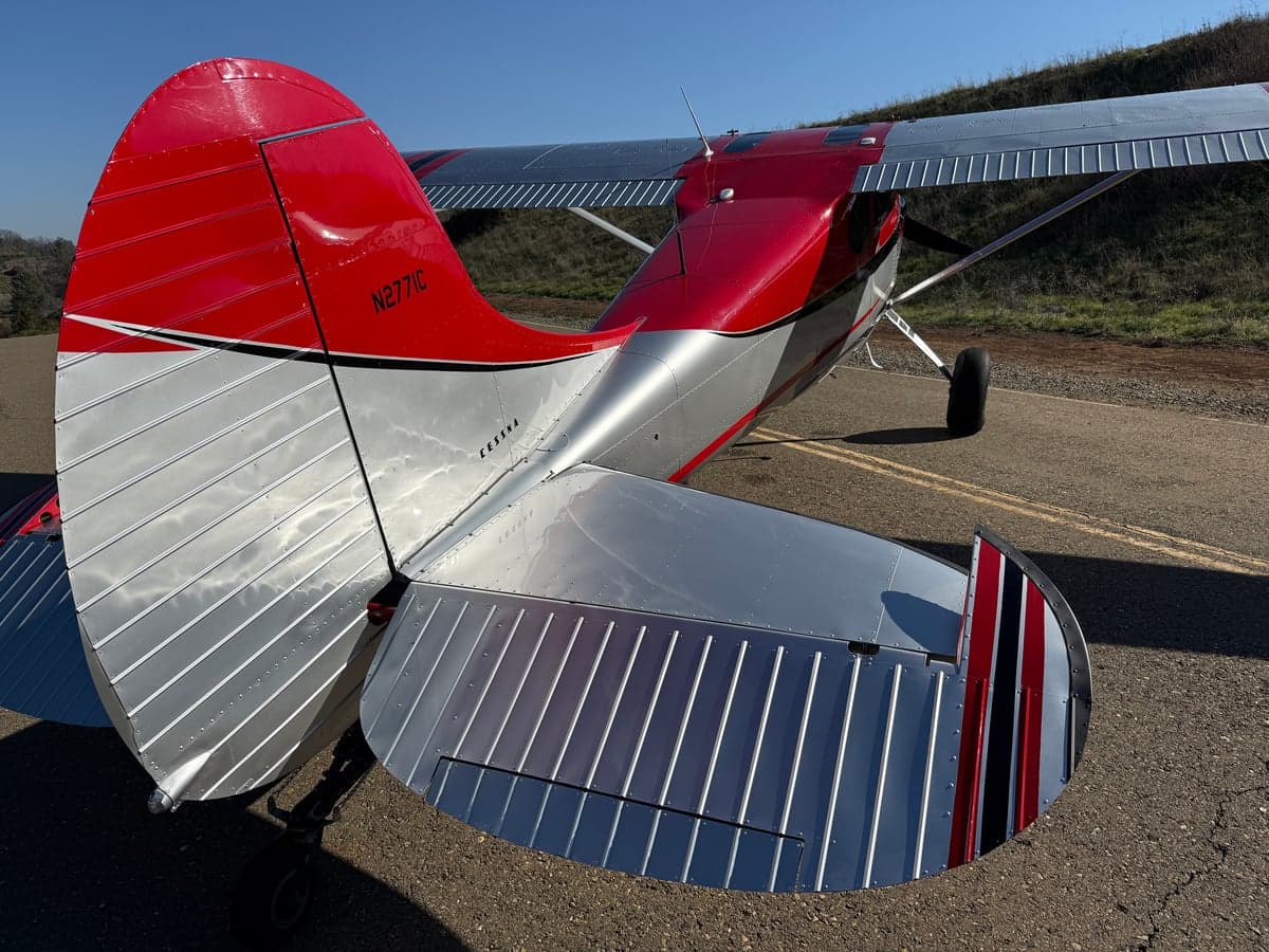The tail of the N2771C aircraft is visible, showing the registration number and red and silver paint scheme.