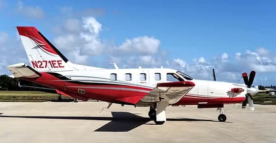 Side view of the N271EE aircraft with a white and red paint scheme.
