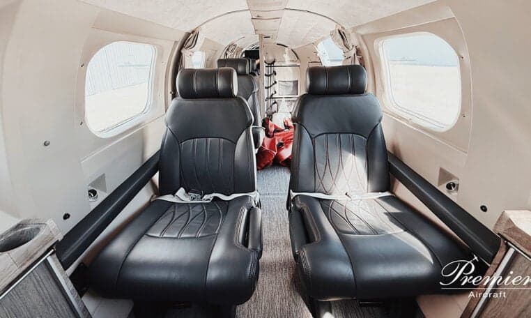 View of the aircraft cabin with black leather seats.