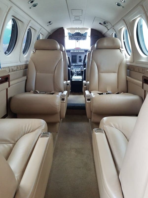 A view of the interior cabin of the aircraft, showing the seating arrangement.