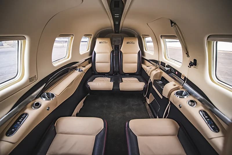 Interior view of the M600 SLS aircraft cabin with leather seats.