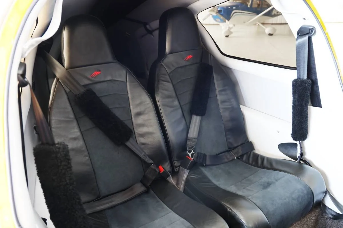 The two black leather passenger seats with seatbelts in the cabin of the Cessna TTx.