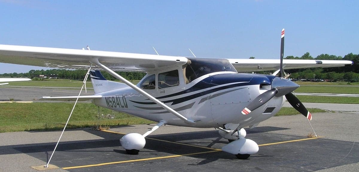 Cessna 182 Skylane with blue and gray paint scheme parked on the tarmac.