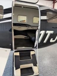 Forward view of the black leather seats in the cabin of the Pilatus PC-12.