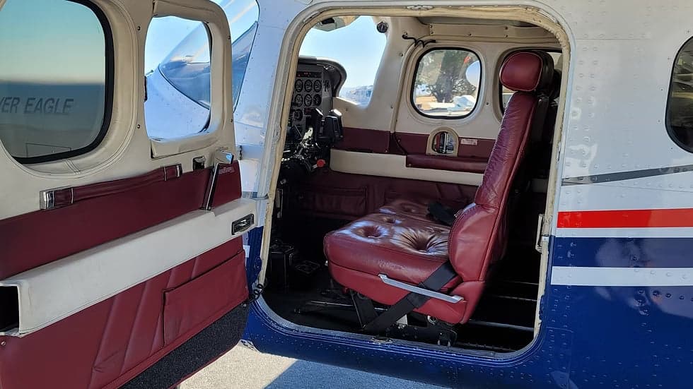 Interior view of the aircraft with red leather seats.