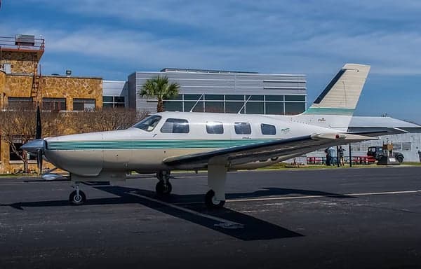Side view of a Piper PA-32R-301 Saratoga II TC aircraft on the tarmac.