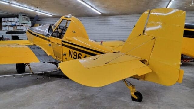 Close-up of the tail and wing of a yellow and black aircraft with the registration number N9646A.