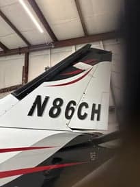 Tail of the aircraft showing the registration number N86CH.