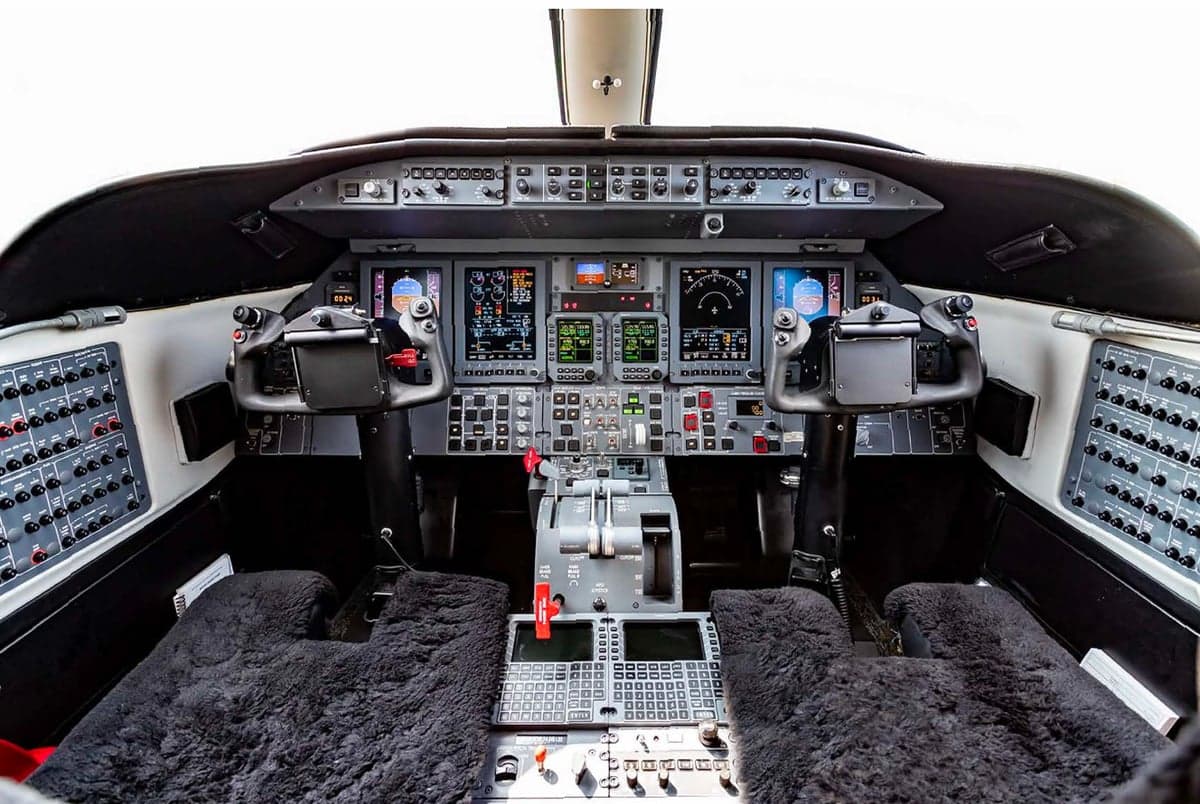 View of the aircraft cockpit with instrument panel and controls.