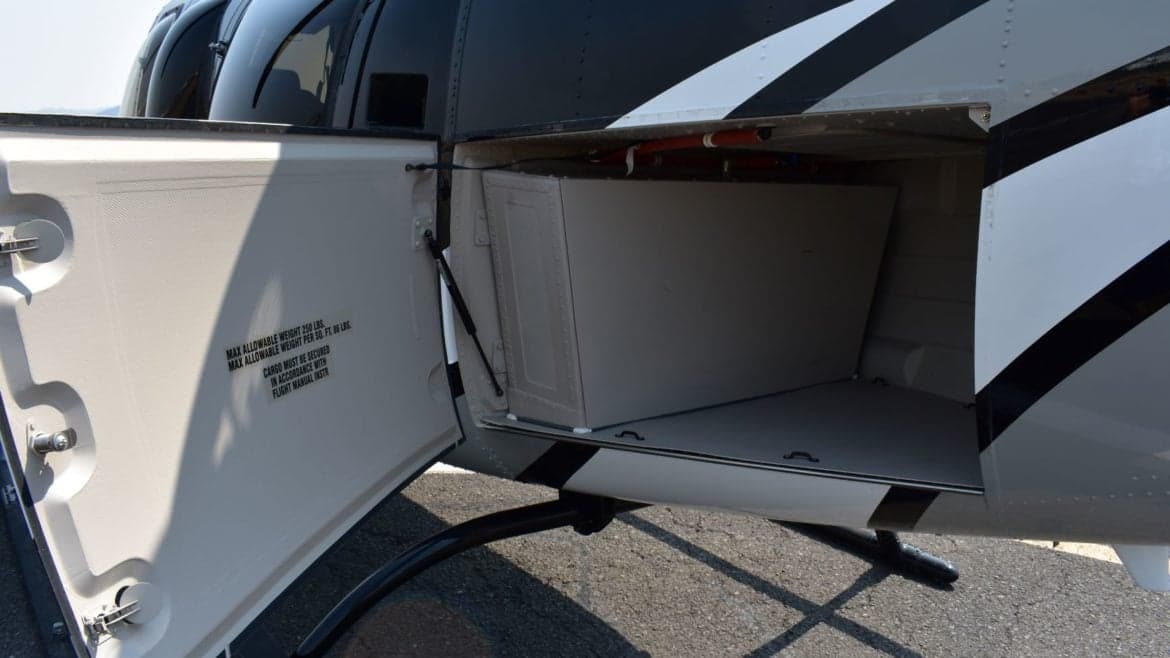 Open storage compartment on a Bell 407GX helicopter.
