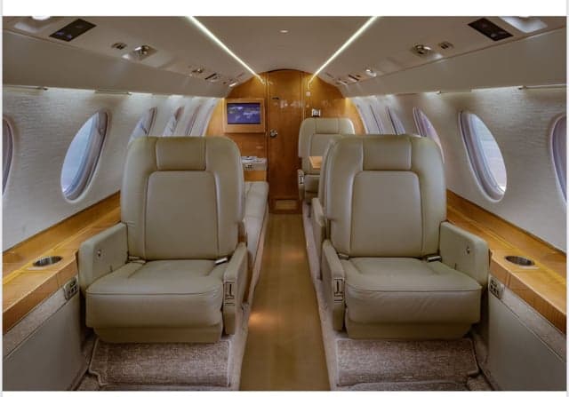 The interior of the Falcon jet, showing the seating arrangement.