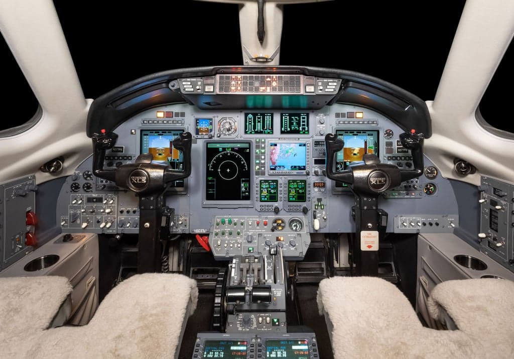 The cockpit of a Cessna Citation CJ3+ aircraft, showing the instrument panel and controls.