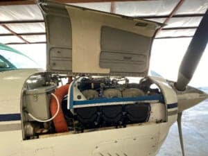 Close-up of the engine of the aircraft with the cowling open.