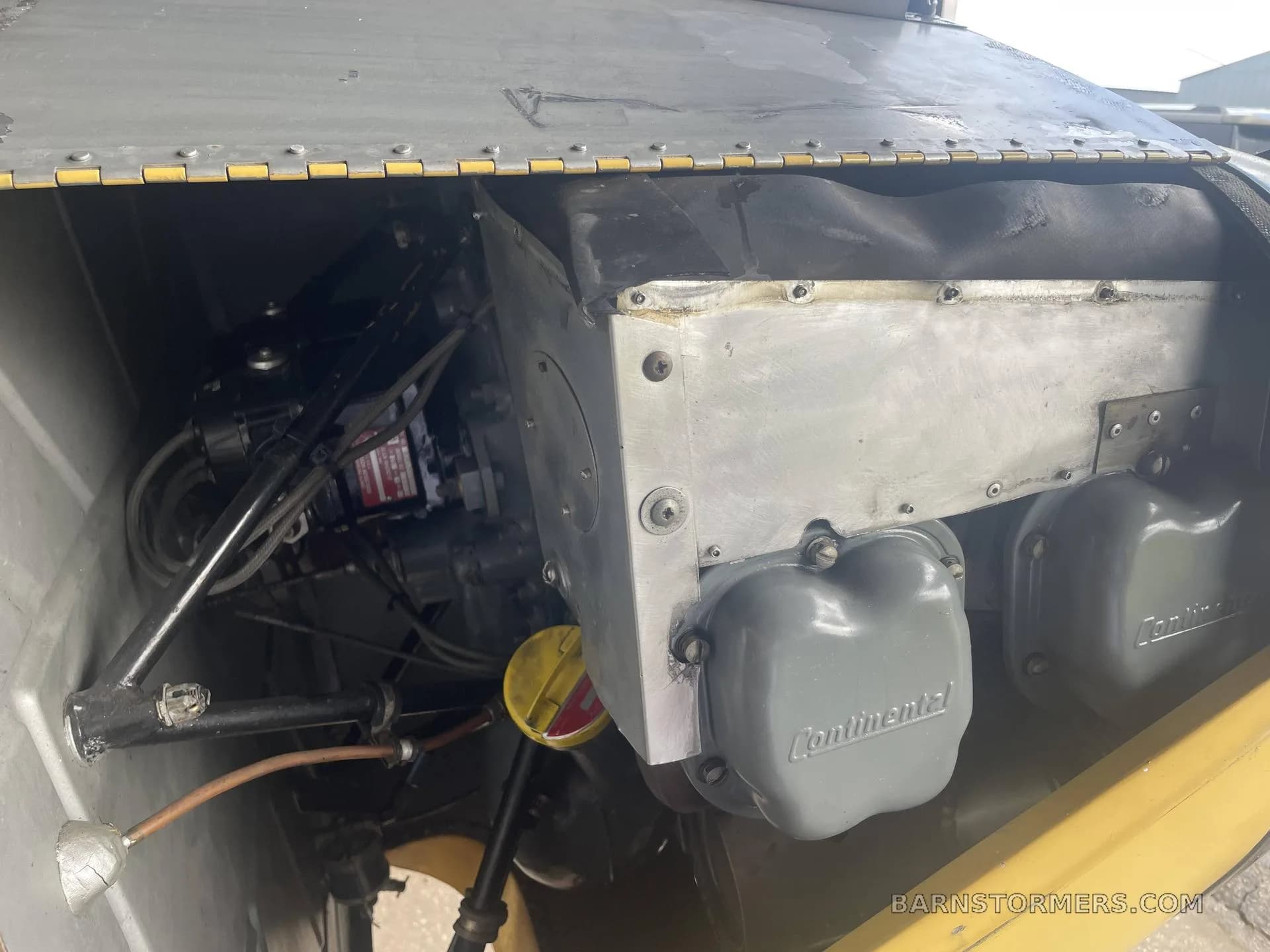 A close-up view of the Continental engine inside the engine compartment of an aircraft.