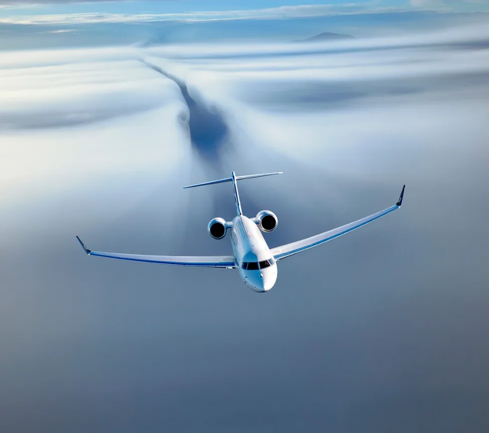 Business jet flying through clouds, rear view.