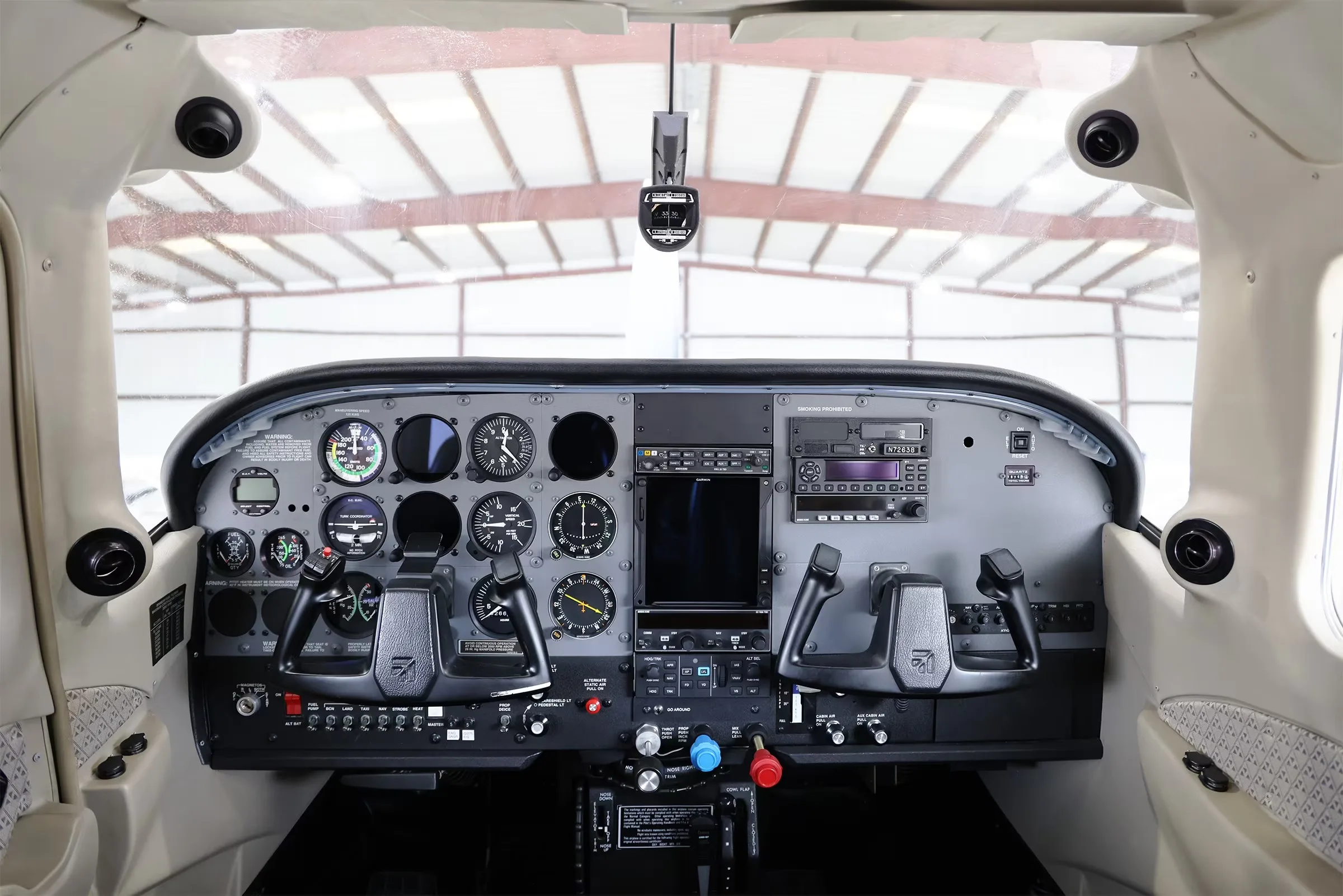 The cockpit of a Cessna Stationair TC aircraft, showing the instrument panel with gauges and controls.