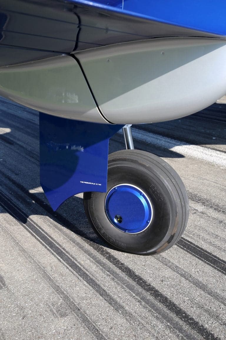Close-up of the landing gear and wheel of a Pilatus PC-12 NGX.