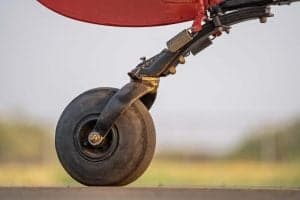Close-up of the aircraft's tail wheel and suspension.