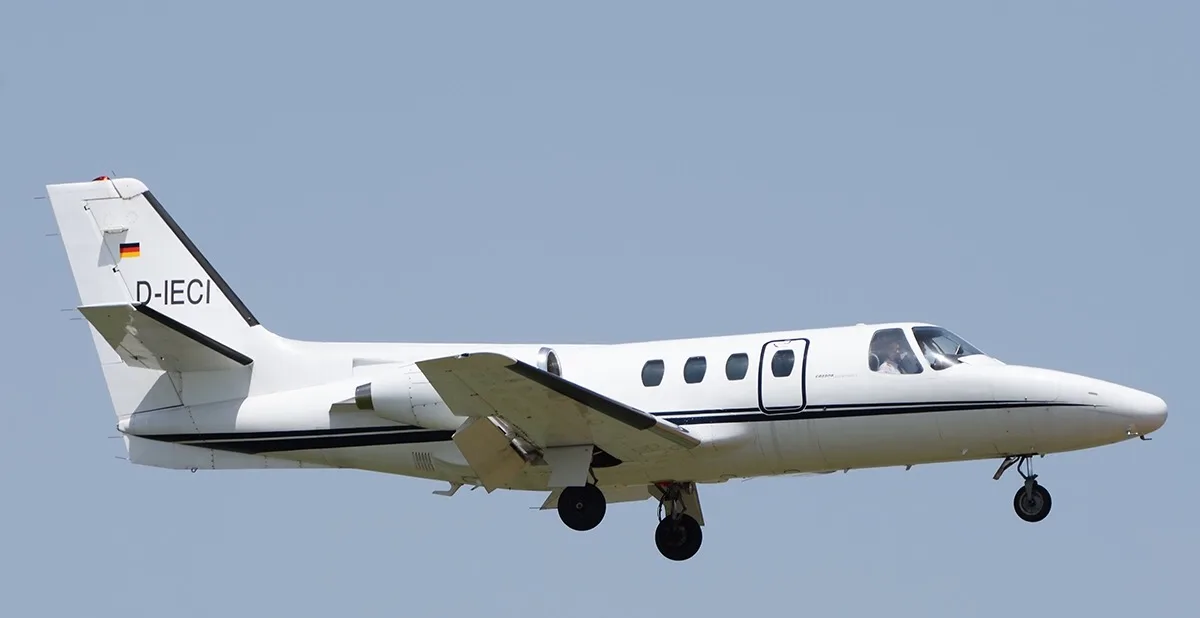 A Cessna Citation Mustang aircraft, registration D-IECI, in flight with landing gear down.
