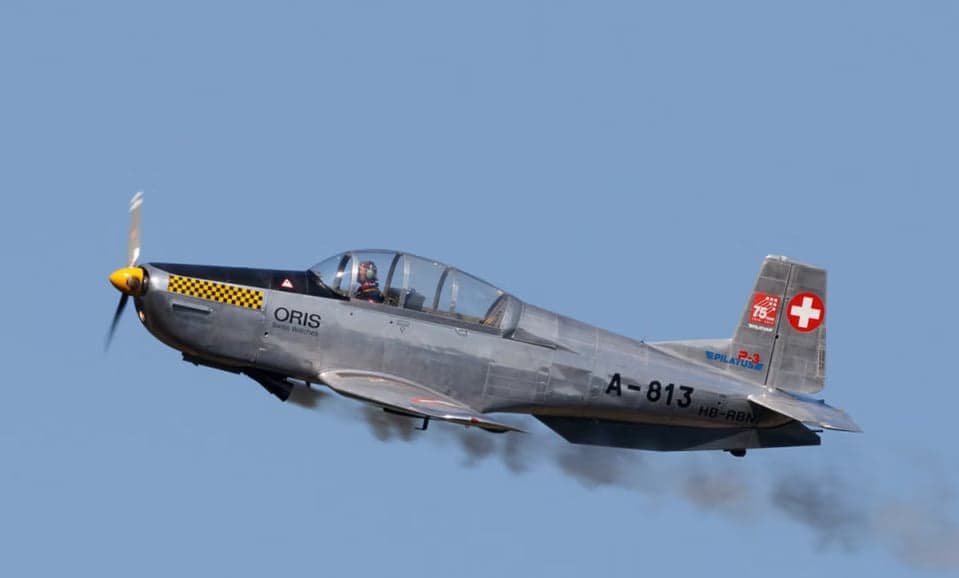 Two Pilatus PC-7 aircraft flying in formation with contrails.