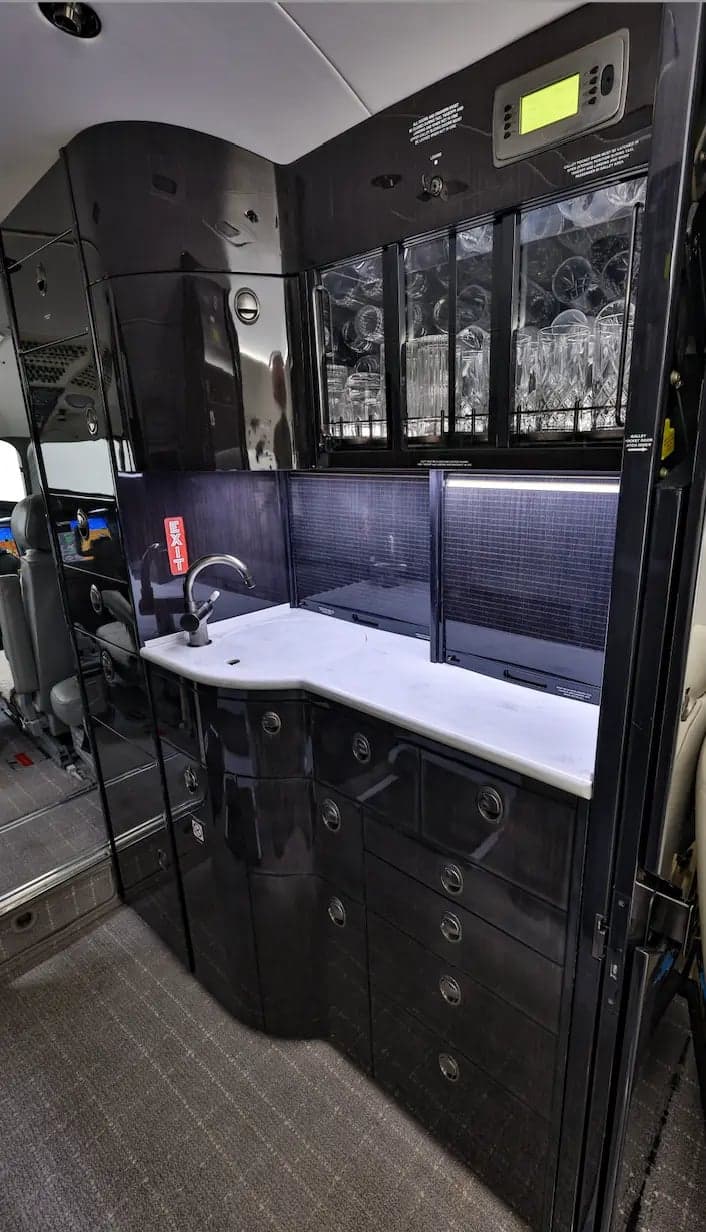 A galley area inside the aircraft with a sink and storage.