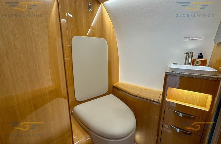 A view of the aircraft's interior with leather seats and a wooden table.