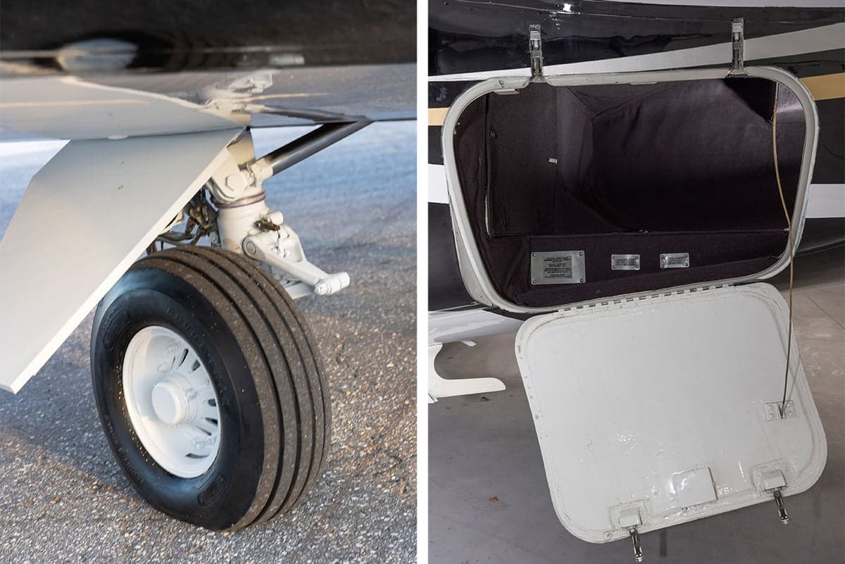 Close-up of the aircraft's landing gear and an open storage compartment.