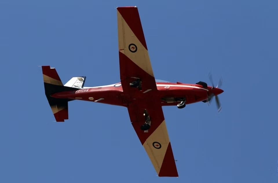 A23-049 aircraft in flight, viewed from below.