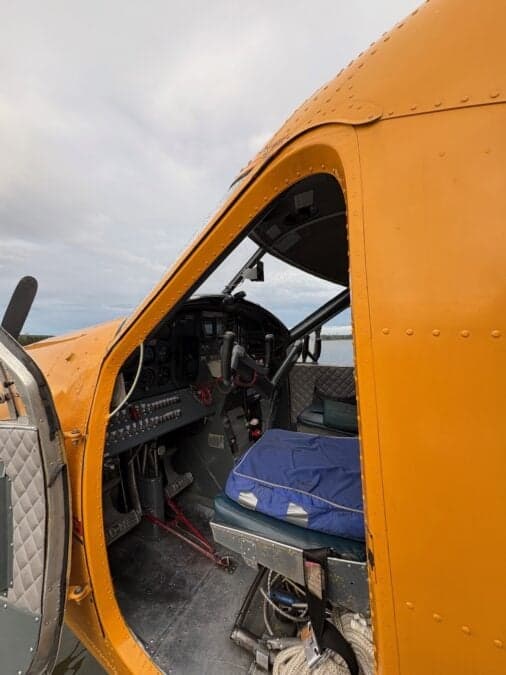 View of the aircraft cockpit with the water visible through the windshield.