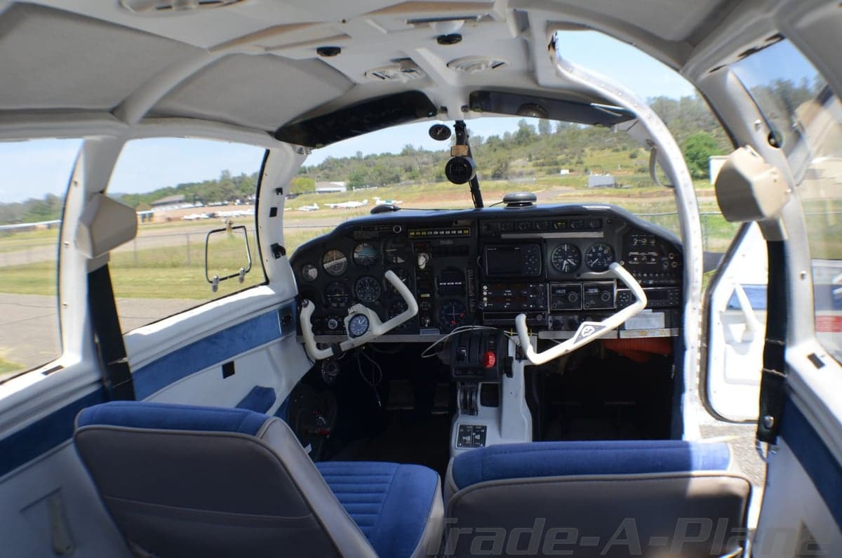 Close-up of the Mooney Executive 21 aircraft's cockpit and windows.