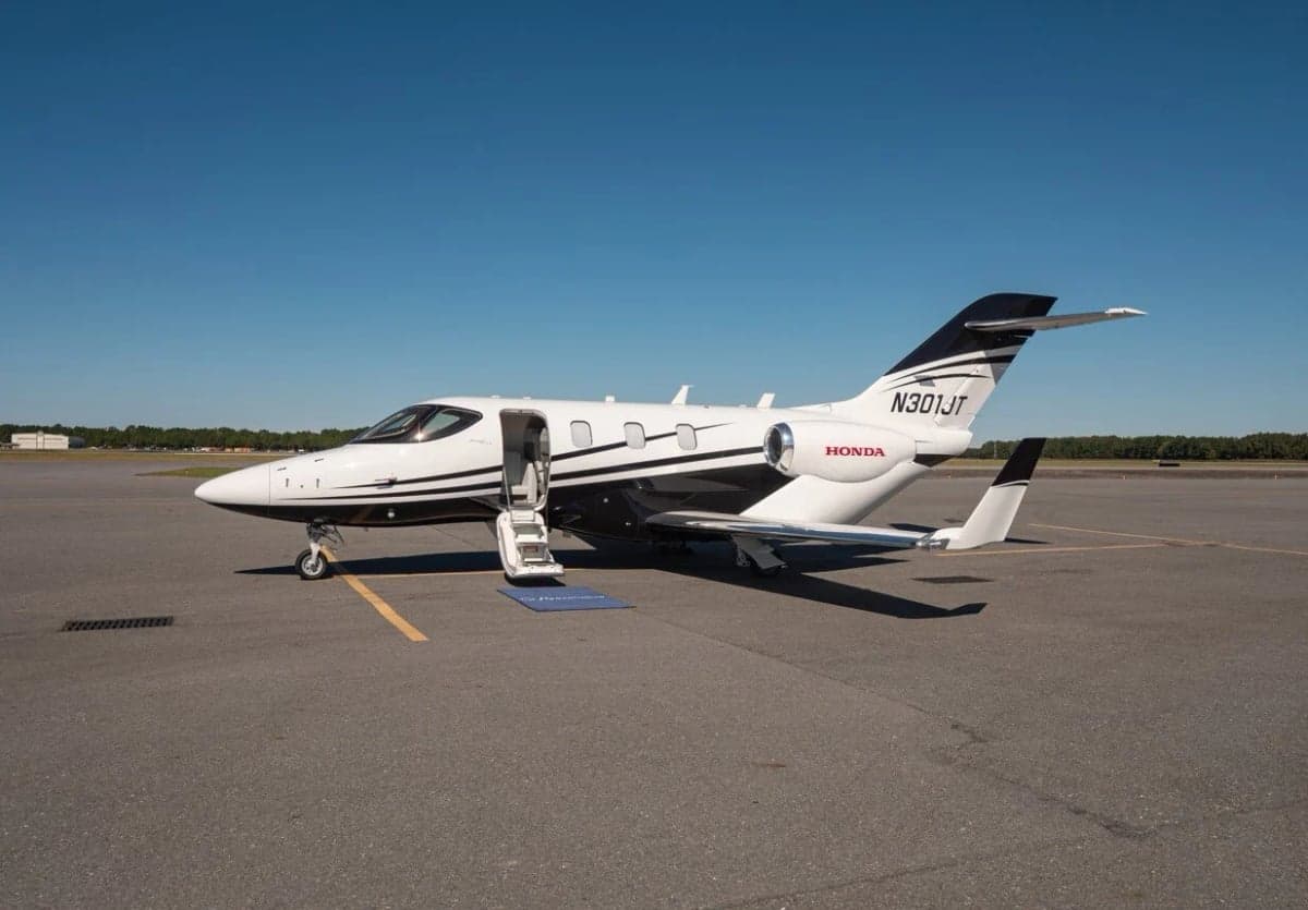 HondaJet Elite S aircraft with open door on the tarmac.