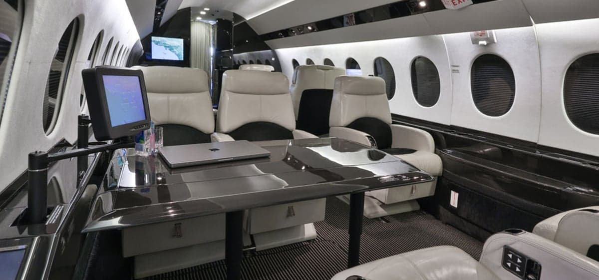 View of the aircraft interior showing seating and tables.