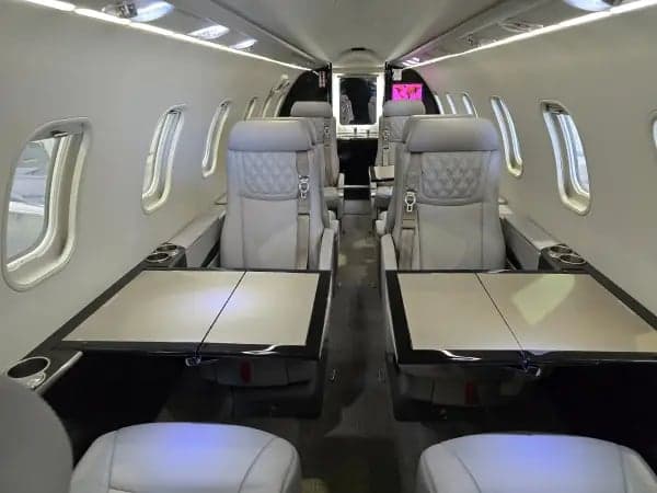 The interior of the aircraft features gray leather seats.