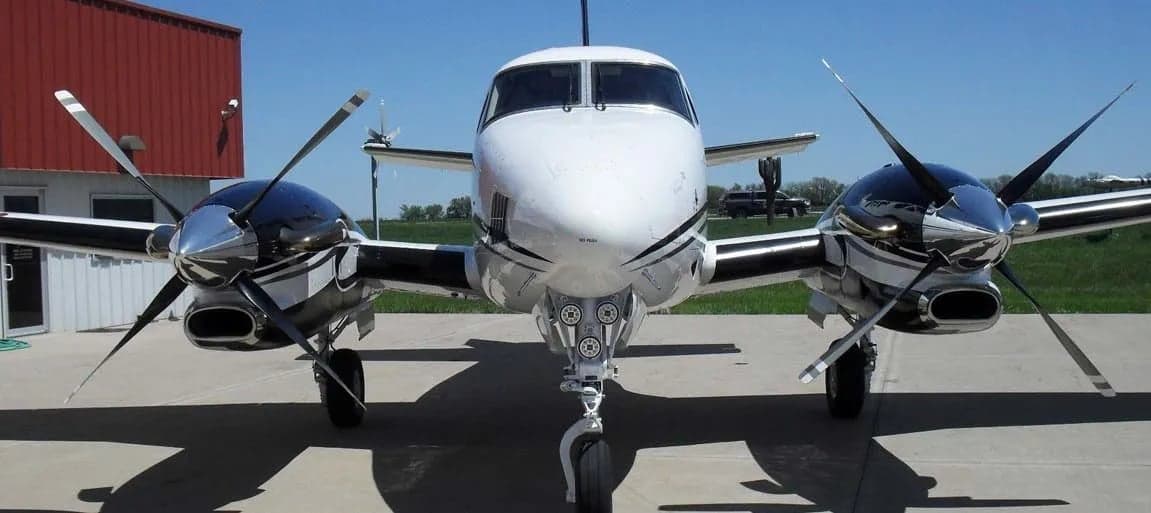 Front view of the Beechcraft King Air C90B aircraft on the tarmac.