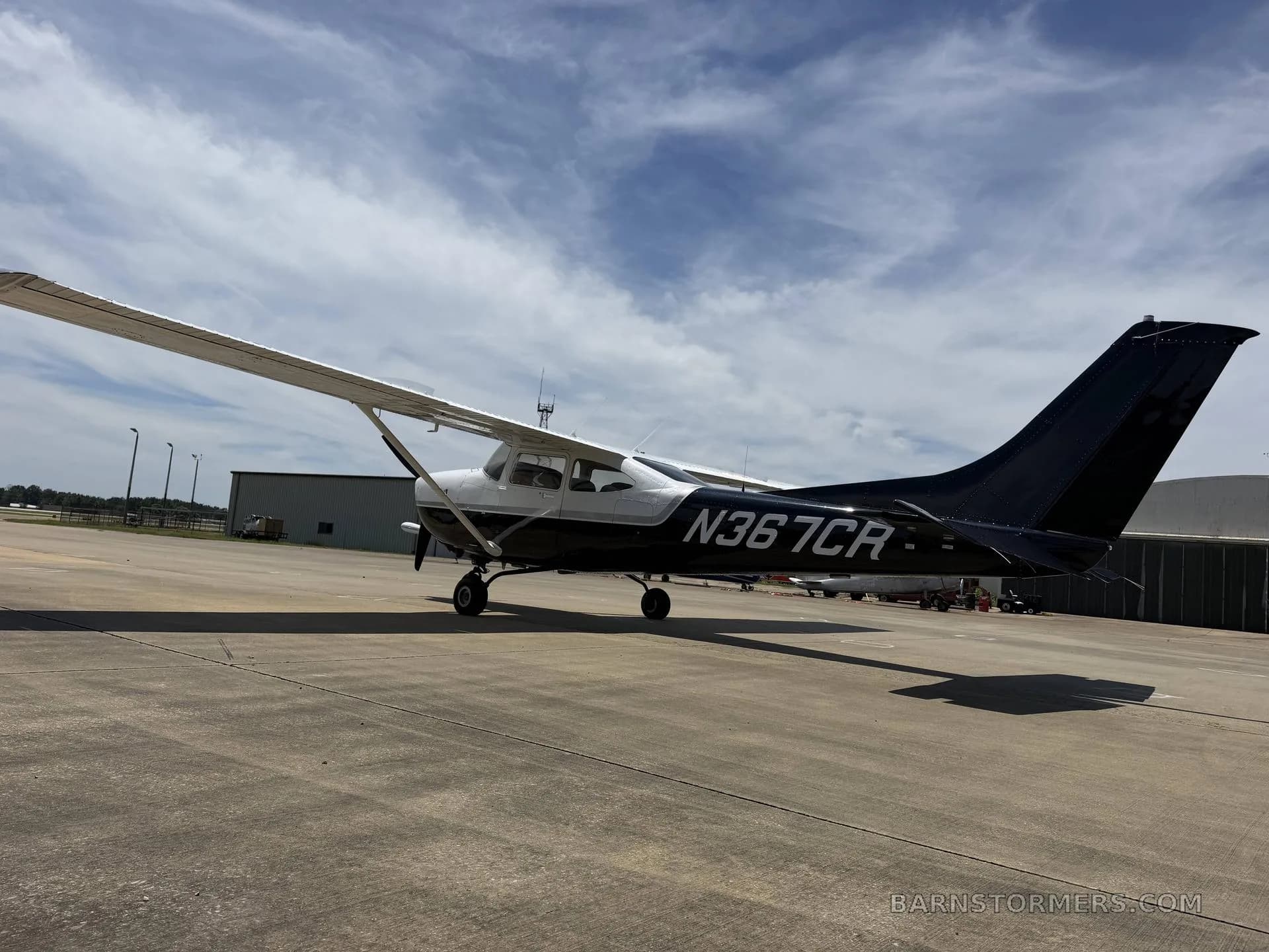 A black and white Cessna 182 Skylane (N367CR) parked on an asphalt ramp, viewed from the left side.
