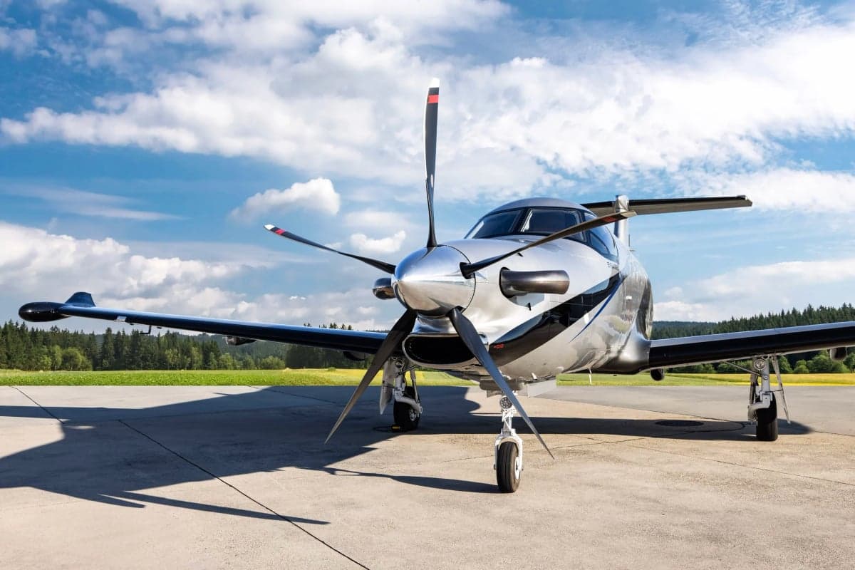 Front view of a Pilatus PC-12NG with a silver and black paint scheme.