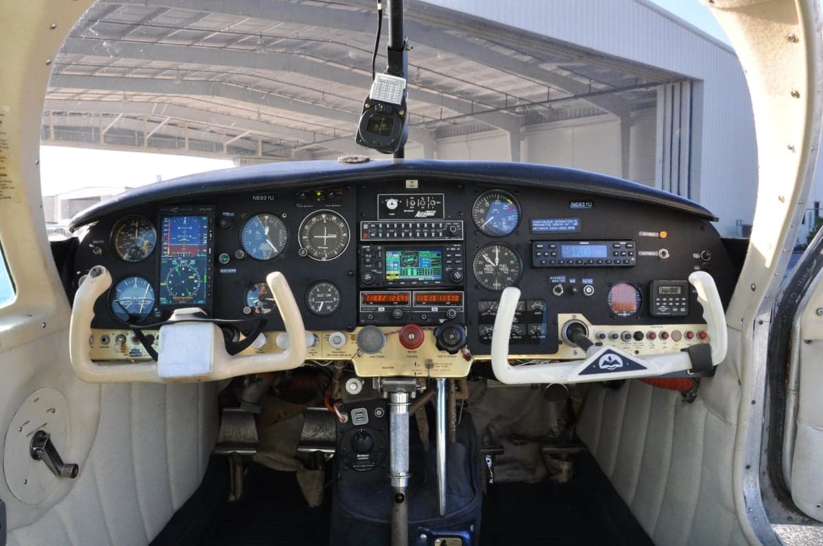 View of the instrument panel and controls inside the cockpit of an aircraft.