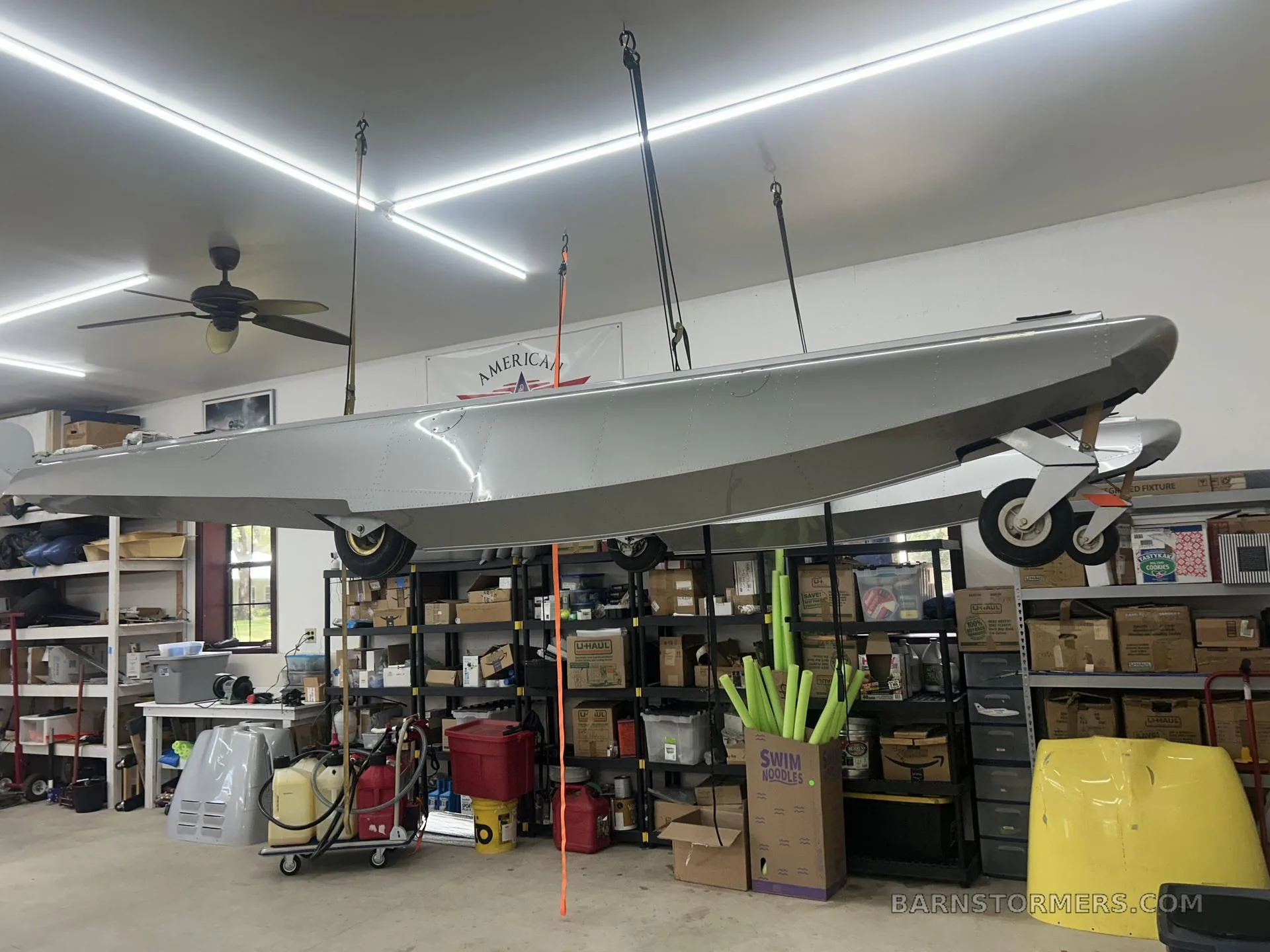A float hanging in a workshop with various tools and equipment.