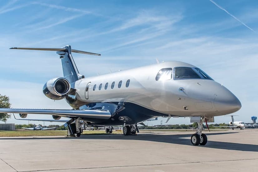A Embraer Phenom 300E parked on the tarmac.