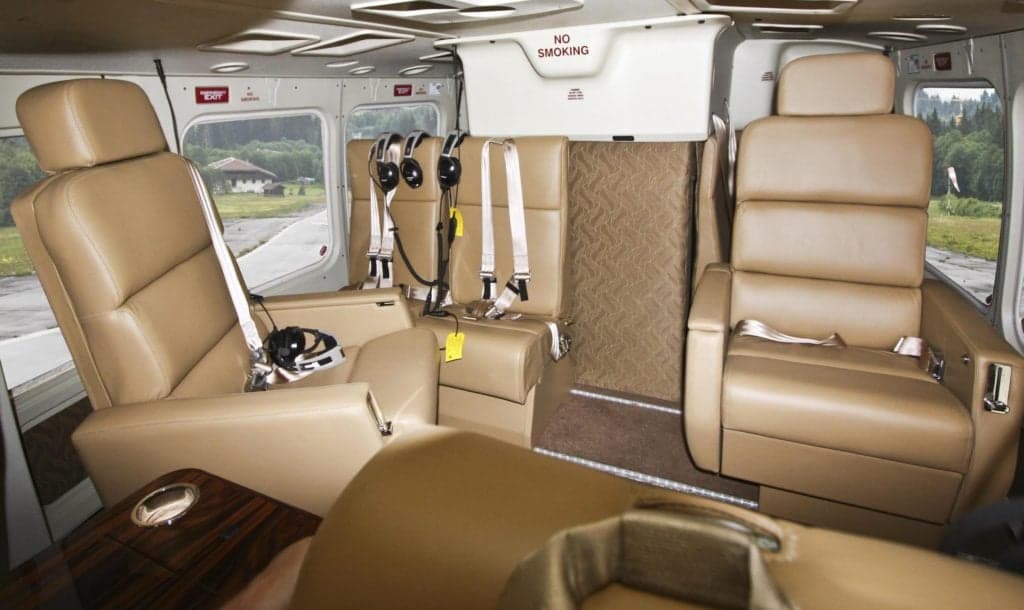 Bell 412 helicopter cabin interior with tan leather seats.