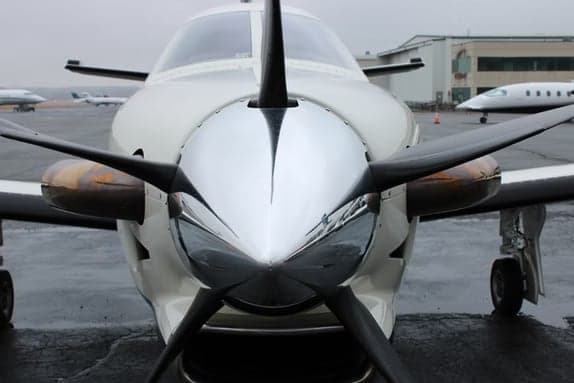 Close up of the propeller and nose of a TBM 930 aircraft.