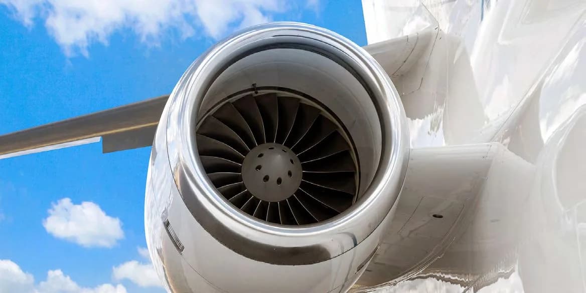 A close-up view of the fan blades inside the engine of a business jet.
