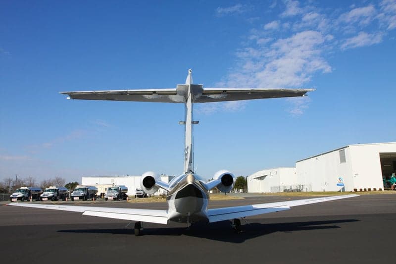 Rear view of a Citation Jet with tail number N915SF on the tarmac.