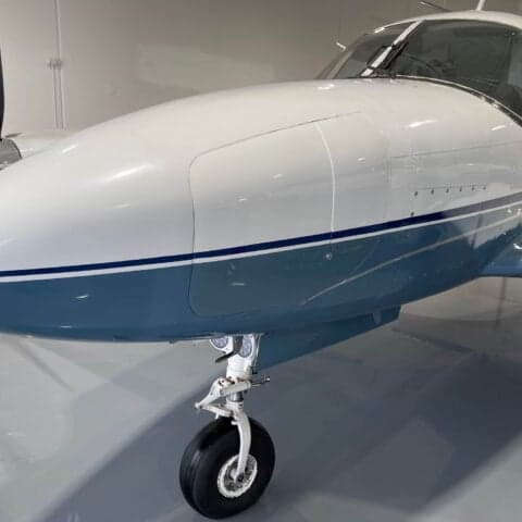 Close-up of the nose and landing gear of a Piper PA-31 Navajo.