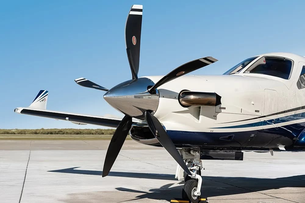 A close-up view of the propeller and front fuselage of the TBM 930 aircraft N930AK.