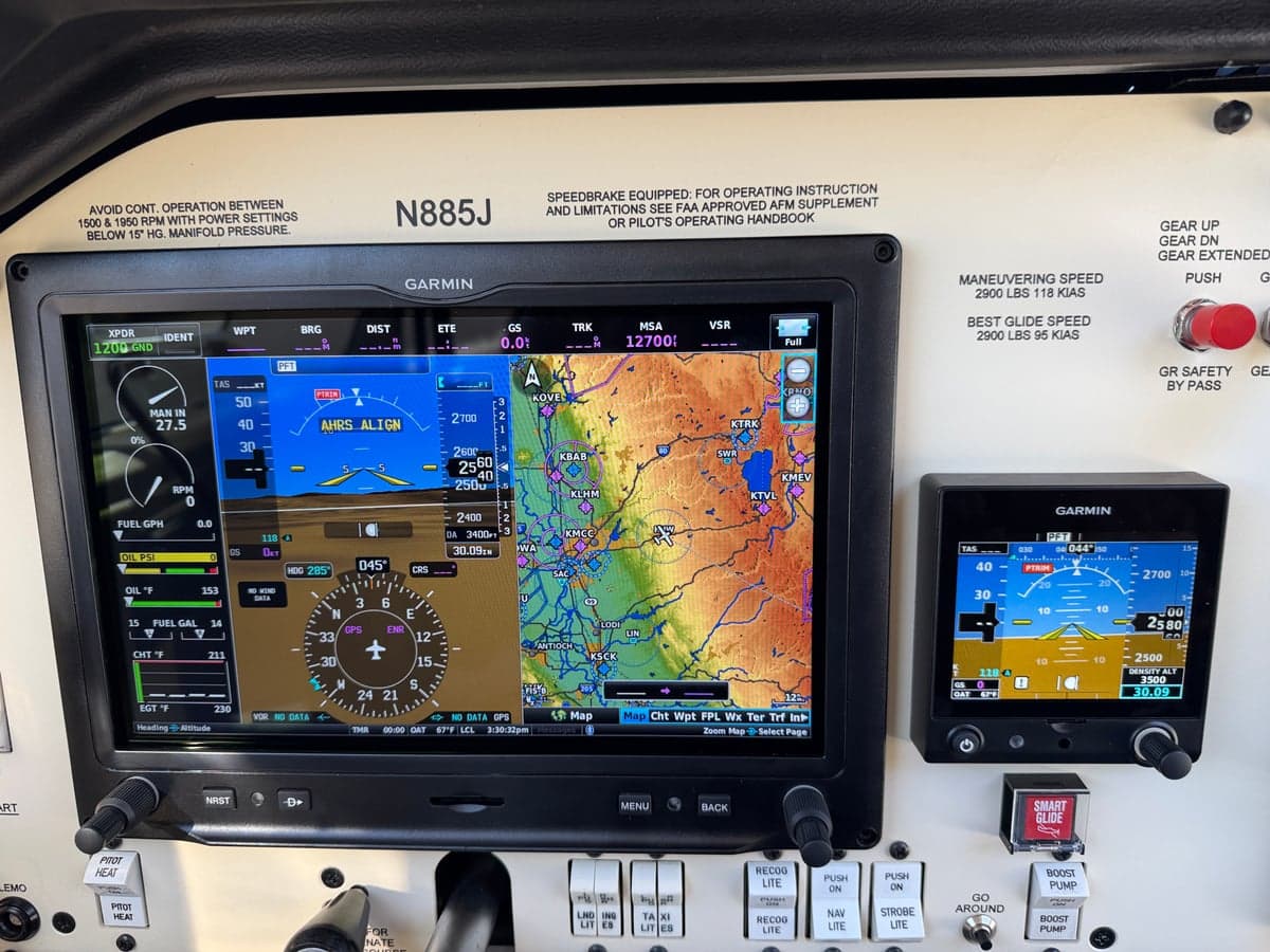 Garmin avionics suite in the cockpit of the Mooney M20J, including a large display showing a moving map.